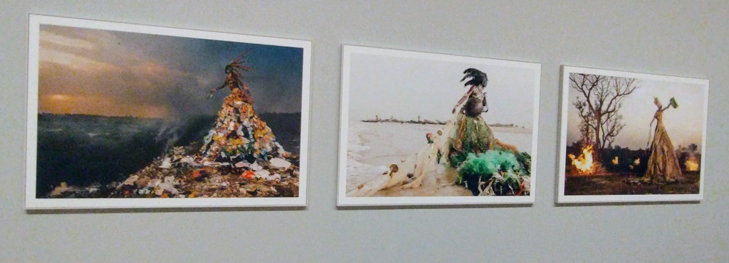 Three picture or paintings. First one has person with big frock made of recycling, possibly waste. 