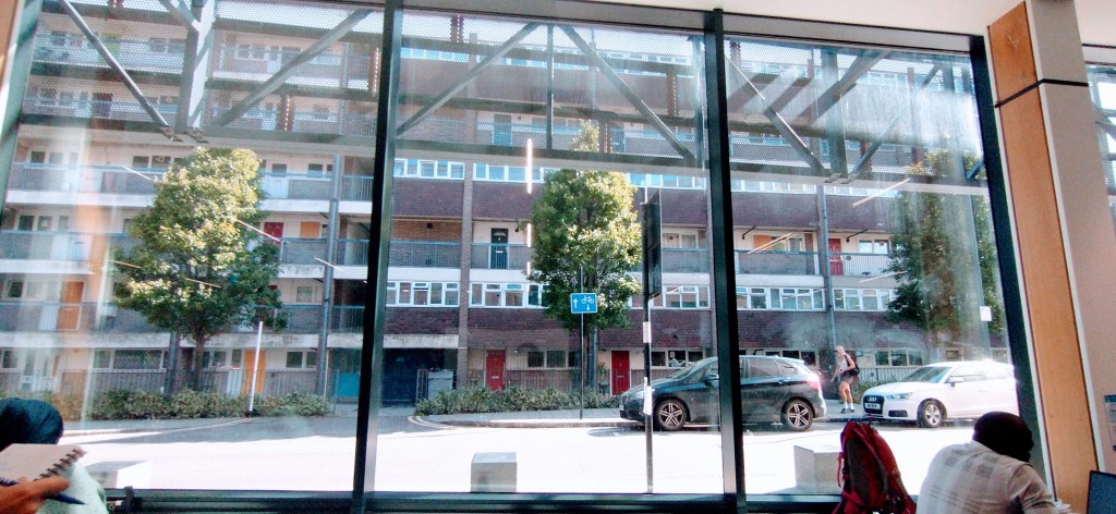 Large windows of Deptford Lounge facing out to flats opposite.